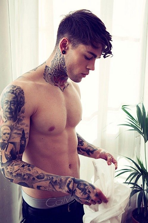 Guy With Neck And Sleeve Tattoos