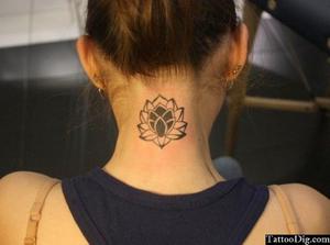 dark-hued lotus flower tattoo on neck